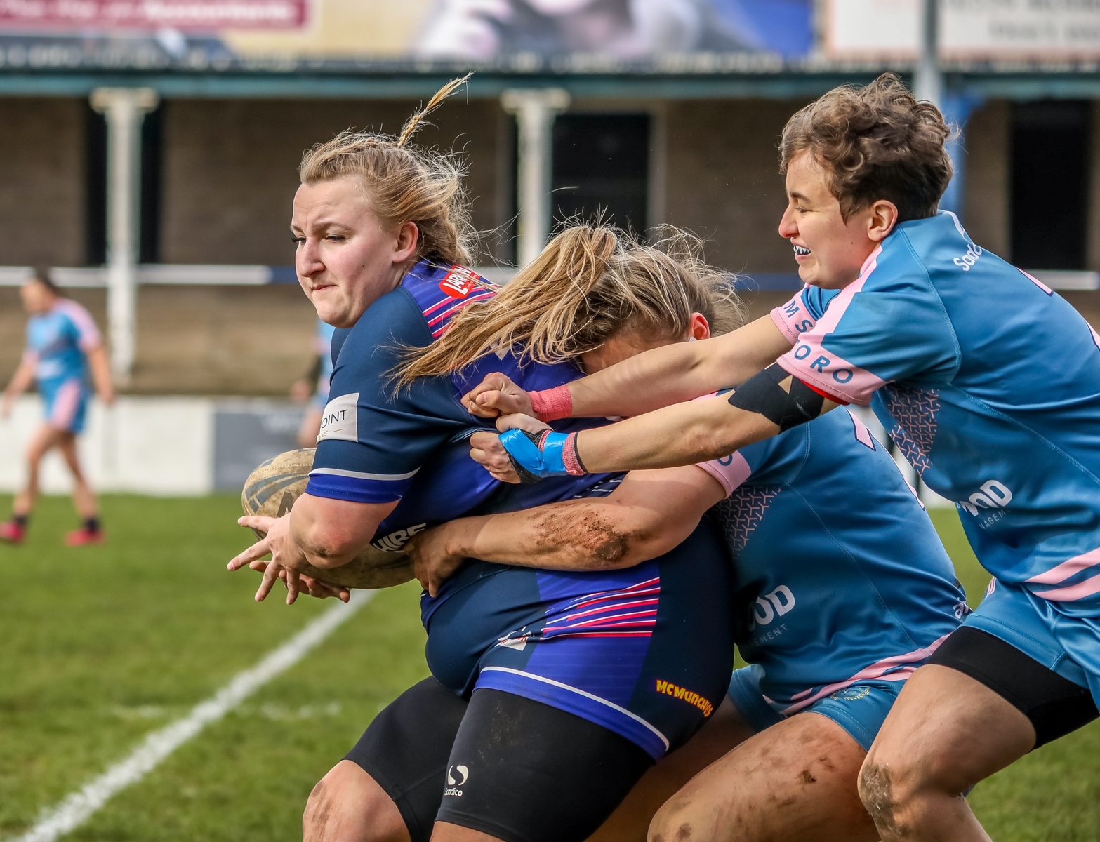 Atoms women making a tackle in a match